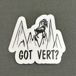 May include: Black and white sticker with a mountain range and a goat standing on top of the highest peak. The text "GOT VERT?" is below the mountains.
