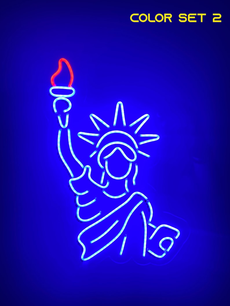 May include: A blue neon outline of the Statue of Liberty holding a torch with a red flame. The background is a dark blue color. The text "COLOR SET 2" is in yellow at the top of the image.