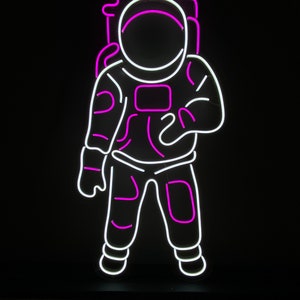 May include: Neon sign of an astronaut in white with pink outlines. The sign says "COLOR SET 6" at the top.