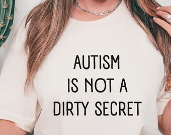 May include: A white t-shirt with the text "AUTISM IS NOT A DIRTY SECRET" printed in black.