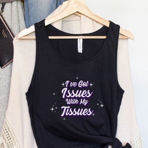 May include: Black tank top with the text "I've Got Issues With My Tissues" in purple with white stars around the text.