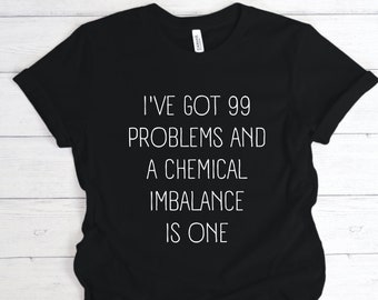 May include: Black t-shirt with white text that reads "I've got 99 problems and a chemical imbalance is one."