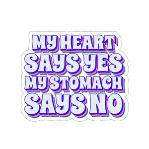 May include: A sticker with a blue, pink, and green outline featuring the text "My heart says yes my stomach says no" in a retro font.