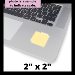 May include: A yellow sticky note with a folder icon on a silver laptop keyboard. The note is 2 inches by 2 inches.
