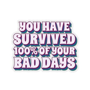 May include: A sticker with a purple, blue, and green outline. The text on the sticker reads "You have survived 100% of your bad days."