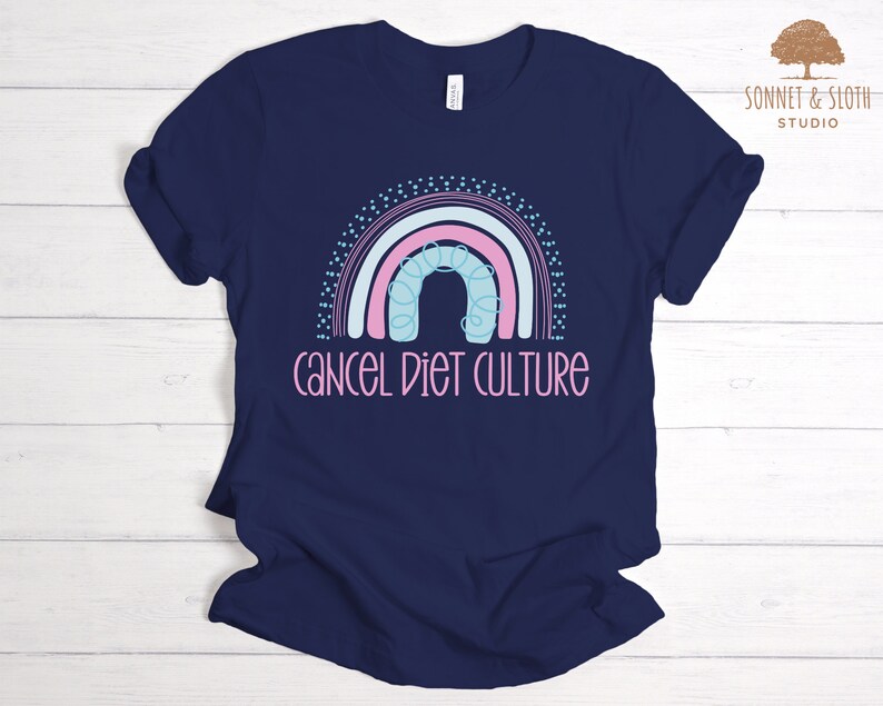 May include: A navy blue t-shirt featuring a rainbow graphic and the text "cancel diet culture".