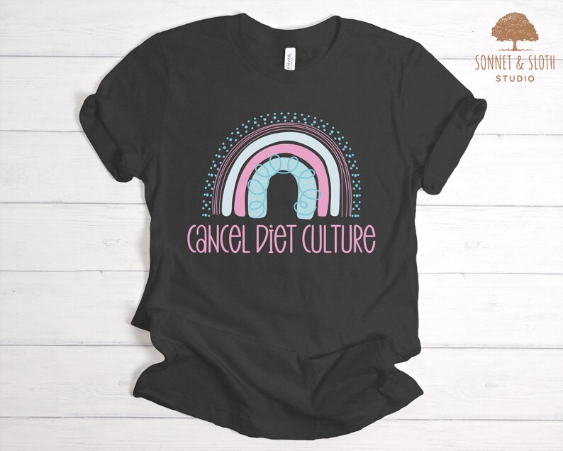 May include: Black t-shirt featuring a rainbow design and the text "cancel diet culture" in pink.