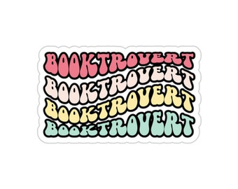 May include: A sticker with the word "BOOKTROVERT" repeated four times in a rainbow of colors, starting with pink and ending with light green.