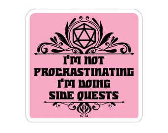 May include: Pink background with a black and white graphic of a 20-sided die with a decorative border. The text reads "I'm not procrastinating I'm doing side quests".