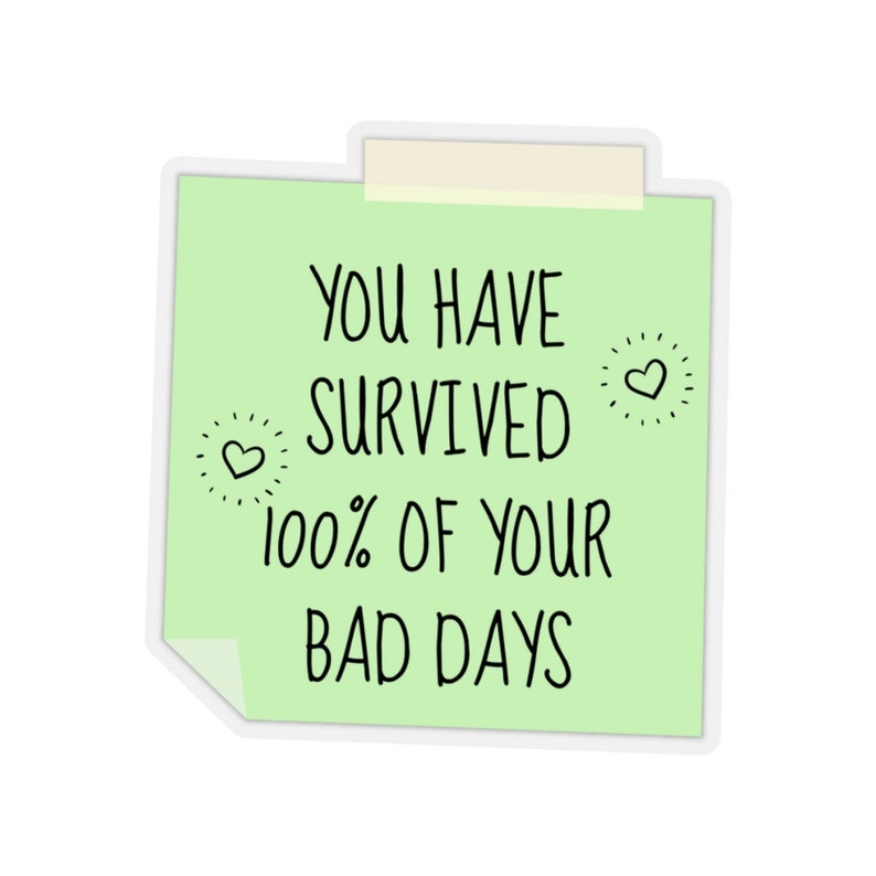 May include: A green sticky note with the text "You have survived 100% of your bad days" with two small hearts drawn on the note.
