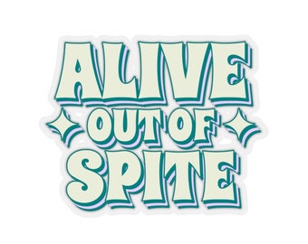 May include: A sticker with the text "Alive Out of Spite" in a retro, colorful font. The text is outlined in teal and purple, with a white background.