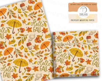 May include: Wrapping paper with a repeating pattern of autumn leaves, umbrellas, coffee cups, and the words "Hello Fall" in a handwritten style. The paper is tied with twine. The text "Autumn Leaves and Umbrellas Themed" and "Premium Wrapping Paper" are also visible.