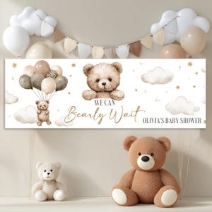 Peut inclure: Une bannière sur le thème des ours en peluche, avec le texte "We Can Bearly Wait" et "Olivia's Baby Shower". La bannière présente une illustration à l'aquarelle d'un ours en peluche tenant des ballons. Deux ours en peluche et des ballons sont également visibles.