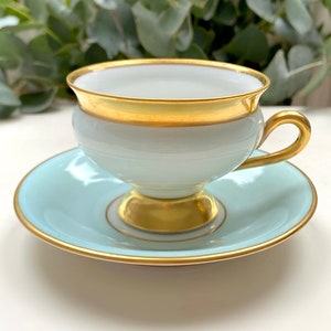 KPM Denmark Antique Empress Pastel Aqua Blue Demitasse Footed Cup and Saucer with Gold Trim and Accent. Made in Denmark