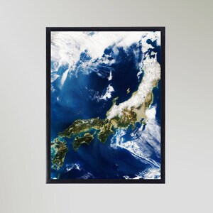 May include: A satellite image of Japan, showing the islands of Honshu, Hokkaido, Kyushu, and Shikoku. The image is taken from space and shows the country's geography, including mountains, rivers, and coastlines. The image is dominated by blue water, with white clouds scattered across the sky.