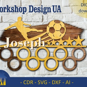 May include: A wooden medal holder featuring a soccer player design, a football, and five stars. The holder has seven medal slots and the name "Joseph" is engraved on the top.