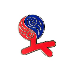 May include: A red and blue enamel pin with a silver border. The design features a stylized yin-yang symbol with a red, curved lower section. The upper portion is divided into blue and red sections with a swirling pattern.