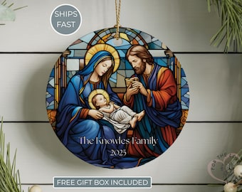 May include: Round Christmas ornament featuring a stained-glass style depiction of the Holy Family. The ornament has a gold string for hanging and includes the text "The Knowles Family 2025".