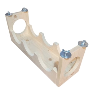 May include: A wooden wine rack with three slots for bottles. The rack is made of unfinished wood and has metal brackets on the sides.