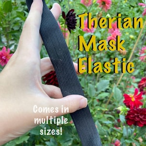 May include: Black Therian Mask Elastic, shown in a close-up view. The elastic is held in a hand, with text that reads "Therian Mask Elastic" and "Comes in multiple sizes!" in a garden setting with red and pink flowers.