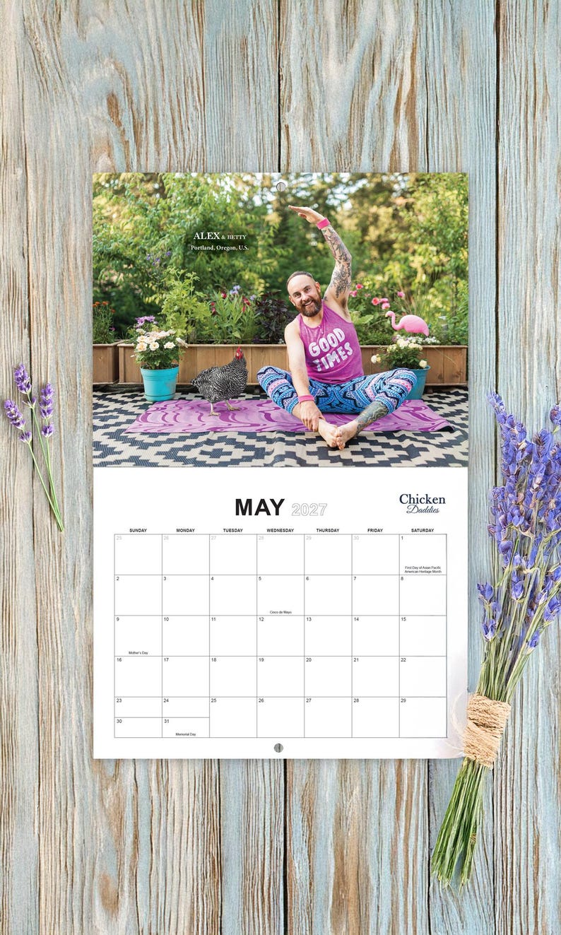 May include: A wall calendar for May 2027 titled Chicken Daddies featuring a photograph of a person in a pink tank top with the text GOOD TIMES and patterned leggings doing yoga on a mat with a chicken in a garden setting.