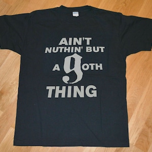 May include: Black t-shirt with white text that reads "Ain't nothin' but a goth thing".