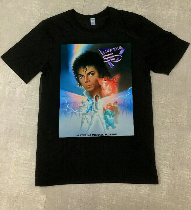 May include: Black t-shirt featuring a graphic of Michael Jackson from Captain EO. The graphic includes the text "CAPTAIN EO" and "FEATURING MICHAEL JACKSON". The image has a blue and purple color scheme with lightning bolts.
