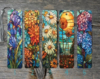 May include: Five different stained glass style bookmarks featuring floral designs. The bookmarks are rectangular and have a hole at the top for hanging. The designs include irises, dahlias, daisies, dandelions, and hydrangeas.