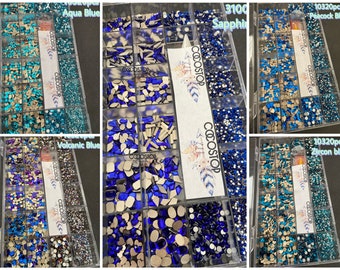 May include: Assortment of blue and silver rhinestones in various shapes and sizes, packaged in a clear plastic box with the word "COCOSTOP" printed on the side. The box contains 10,320 pieces of rhinestones in total.