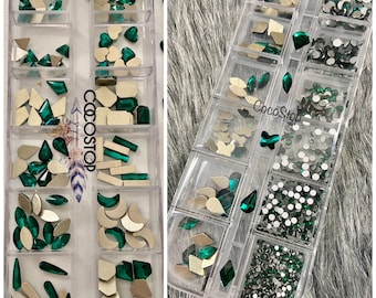 May include: Two clear plastic containers filled with various green and silver nail art embellishments. The containers are labeled "CocoStop".