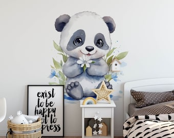 May include: A watercolor illustration of a cute panda bear holding a white flower. The panda is sitting on a blue surface with green leaves and blue flowers around it. There is a small birdhouse with a blue roof in the background. The illustration is on a white wall in a nursery room with a white nightstand and a bed with a black and white patterned duvet.