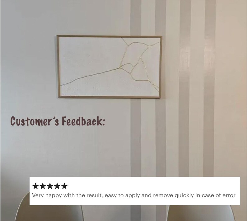 May include: A framed artwork with a white background and gold-colored lines, resembling a fractured design. The frame is a light brown color. The text "Customer's Feedback:" is visible. Below the artwork is a customer review.