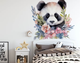May include: A watercolor illustration of a panda bear's face surrounded by pink and blue flowers. The illustration is on a white wall above a white bed with a black and white patterned duvet.