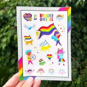 May include: A rectangular sticker sheet featuring the text BFE STICKER CLUB and BROOKE O'NEILL. The sheet contains various colorful illustrations including a large pride flag, a cat, a dog, a frog, and several characters holding smaller pride flags.
