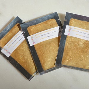 May include: Three individual packets of gold edible glitter, each with a label that reads "Sprinklify" and "BRIGHT GOLD EDIBLE GLITTER" with the ingredients listed as "Mica-Based Pearlescent, Iron Oxide" and "Distributed By: Sprinklify LLC".
