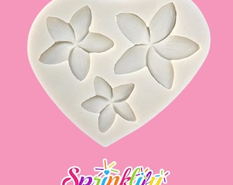 May include: A white silicone mold in the shape of a heart, featuring three flower impressions. The flowers have five petals each. The word "Sprinklify" is written in colorful script at the bottom of the image.