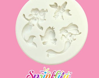 May include: A white silicone mold featuring mermaid and sea creature designs. The mold includes two mermaids, a fish, and a starfish. The word "Sprinklify" is written in colorful script at the bottom of the image.