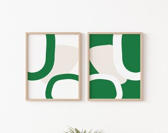 May include: Two framed abstract art prints with a green and white design. The prints feature organic shapes and lines in a minimalist style.