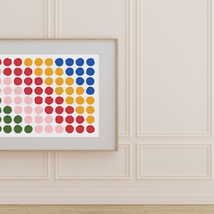May include: A framed print of a colorful abstract design featuring a grid of circles in shades of green, pink, red, yellow, and blue.
