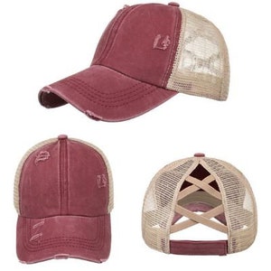 May include: A red and beige baseball cap with a mesh back. The cap has a distressed look and a criss-cross design on the back.