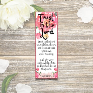 May include: A pink floral bookmark with the text "Trust in the Lord" and a Bible verse from Proverbs 3:5-6. The bookmark features a watercolour design with pink flowers and green leaves.