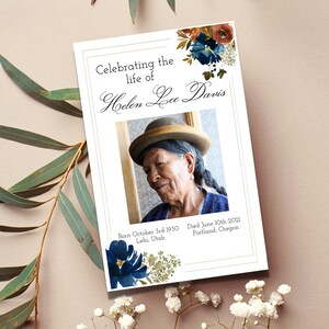 May include: A white memorial card with a photo of a woman wearing a hat. The card has a floral design and the text "Celebrating the life of Helen Lee Davis" and "Born October 3rd 1930 Lehi, Utah Died June 10th 2021 Portland, Oregon."