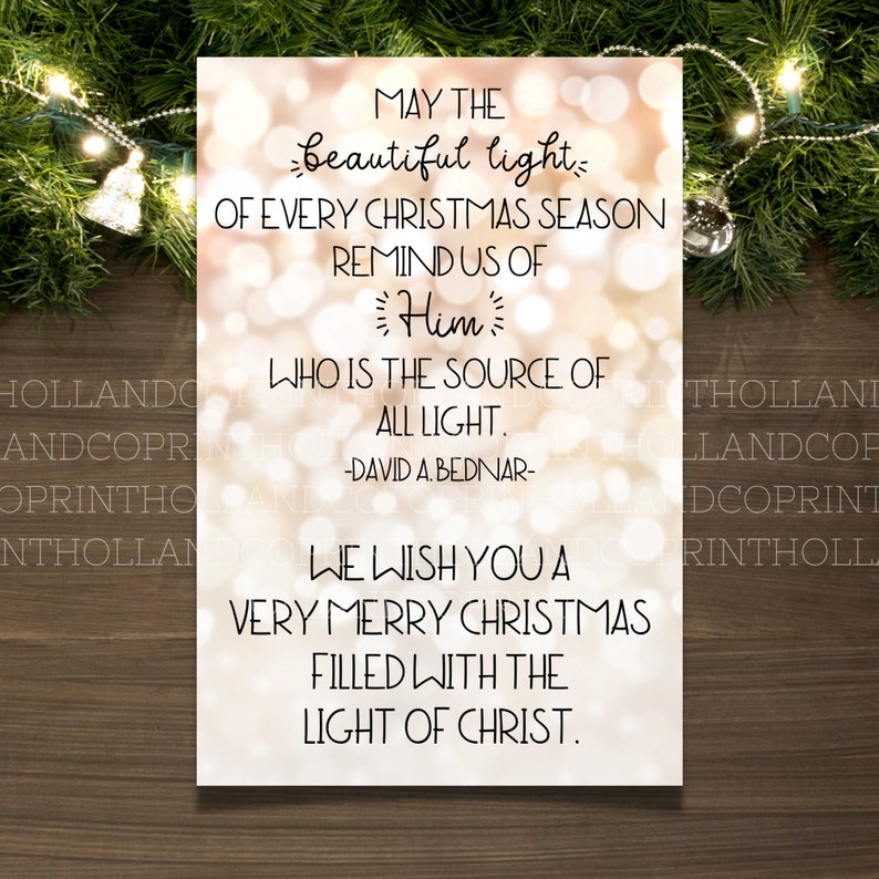 May include: A Christmas card with a gold and white background featuring a quote about the light of Christ. The quote reads: "May the beautiful light of every Christmas season remind us of Him who is the source of all light. -David A. Bednar- We wish you a very Merry Christmas filled with the light of Christ."