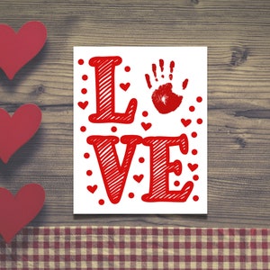 May include: White background with the word "LOVE" in red with a handprint in the center of the word. The letters are outlined in black and have a textured look. There are small red hearts scattered around the word.