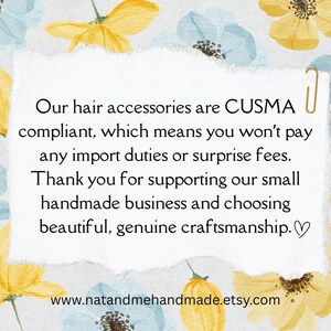 May include: A white paper with text about hair accessories, CUSMA compliance, and supporting a small handmade business. The paper is decorated with watercolour flowers in yellow and blue.