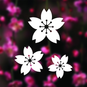 May include: Three white paper cutouts of cherry blossoms on a blurred background of pink flowers.