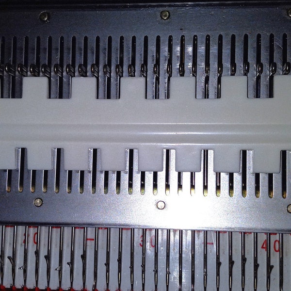 Needle selection tool for standard knitting machines and ribbers.