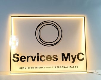 May include: A white illuminated sign with a black circle logo and the text "Services MyC" and "Servicios Migratorios Personalizados".