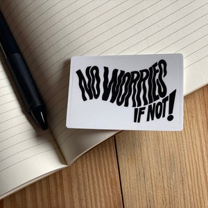May include: White sticker with black text that reads "No Worries If Not!" in a wavy font.