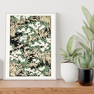 May include: A framed print with a black background and a repeating pattern of white flowers, green leaves, and yellow branches.